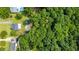 Expansive wooded lot with a house, shed, and blue inground swimming pool in the back yard at 701 Creekside Dr, Clayton, NC 27520