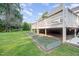 Landscaped backyard featuring a covered deck and metal raised garden beds at 701 Creekside Dr, Clayton, NC 27520