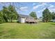 Lush backyard featuring a spacious deck, raised garden beds, and a well-maintained lawn, great for outdoor gatherings at 701 Creekside Dr, Clayton, NC 27520