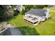 Aerial view of large backyard with patio umbrellas on the large deck, and a garden at 701 Creekside Dr, Clayton, NC 27520