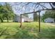 Inviting backyard featuring a deck, swing set, and a storage shed, surrounded by mature trees at 701 Creekside Dr, Clayton, NC 27520
