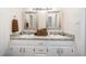 Bathroom featuring a double vanity with granite countertops, white cabinets, and chrome faucets at 701 Creekside Dr, Clayton, NC 27520
