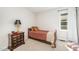 Cozy bedroom featuring carpet and a wooden bedframe, illuminated by natural light from the nearby window at 701 Creekside Dr, Clayton, NC 27520
