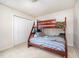 Cozy bedroom featuring carpet and bunkbeds, and a closet for convenient storage at 701 Creekside Dr, Clayton, NC 27520