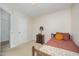 Comfortable bedroom featuring carpet, a bed, and a wood dresser, with a closet for convenient storage at 701 Creekside Dr, Clayton, NC 27520