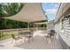 Expansive backyard deck with multiple seating areas and sun shade canopies at 701 Creekside Dr, Clayton, NC 27520