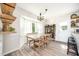 Bright dining room featuring a bay window, stylish chandelier, and hardwood floors at 701 Creekside Dr, Clayton, NC 27520