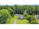 Exterior view of a well-kept lawn, gravel driveway, and wooded backyard at 701 Creekside Dr, Clayton, NC 27520