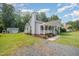 Well-maintained home with mature trees and a detached garage on a spacious lot at 701 Creekside Dr, Clayton, NC 27520