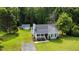 Exterior of home with gray siding, covered porch, and manicured front lawn and shed at 701 Creekside Dr, Clayton, NC 27520