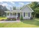 Charming single Gathering home with a well-maintained lawn and inviting front porch at 701 Creekside Dr, Clayton, NC 27520