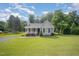 Inviting single Gathering home with well-manicured lawn and mature trees in the background at 701 Creekside Dr, Clayton, NC 27520