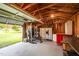 Garage interior featuring weightlifting equipment, workbench, and additional storage at 701 Creekside Dr, Clayton, NC 27520