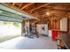 Well-equipped garage interior with weightlifting, workspace, fridge, and custom shelving at 701 Creekside Dr, Clayton, NC 27520