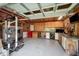 Garage interior featuring plywood walls, workbenches, and organized storage solutions at 701 Creekside Dr, Clayton, NC 27520