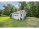 Detached garage with a classic garage door and convenient side entrance at 701 Creekside Dr, Clayton, NC 27520
