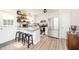 Bright kitchen features an island with granite countertops, stainless appliances, and open shelving at 701 Creekside Dr, Clayton, NC 27520