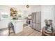Bright kitchen features an island with granite countertops, stainless appliances, and open shelving at 701 Creekside Dr, Clayton, NC 27520