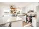 Bright kitchen features an island with granite countertops, stainless appliances, and open shelving at 701 Creekside Dr, Clayton, NC 27520