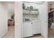 Convenient laundry closet with modern washer and dryer units, and plenty of shelves at 701 Creekside Dr, Clayton, NC 27520