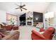 Cozy living room with a decorative fireplace, ceiling fan, and comfortable seating at 701 Creekside Dr, Clayton, NC 27520