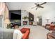 Spacious living room with stone fireplace, ceiling fan, and ample seating at 701 Creekside Dr, Clayton, NC 27520