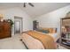 Cozy main bedroom featuring a ceiling fan, plush carpet, and built-in shelving at 701 Creekside Dr, Clayton, NC 27520