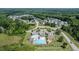 A high angle view of the community pool area and several well-maintained neighborhood homes surrounded by mature trees at 77 Redpine Ct, Clayton, NC 27520