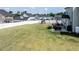 Spacious backyard features a patio, play set, and white privacy fence, perfect for outdoor enjoyment at 77 Redpine Ct, Clayton, NC 27520