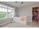 Bright bedroom with large window, neutral walls, and built-in storage under daybed, a comfortable space at 77 Redpine Ct, Clayton, NC 27520