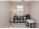 Bright bedroom featuring neutral colored walls and carpeting, a table with chairs, and a large window at 77 Redpine Ct, Clayton, NC 27520