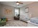 Charming Bedroom with a crib, armchair, and world map wall decor for a cozy atmosphere at 77 Redpine Ct, Clayton, NC 27520