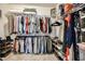 Organized walk-in closet with hanging rods, shelves, and ample space for storage of clothing and accessories at 77 Redpine Ct, Clayton, NC 27520