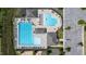 Overhead shot of community swimming pools, pool furniture, and a parking area at 77 Redpine Ct, Clayton, NC 27520