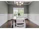 Elegant dining room with a coffered ceiling, modern chandelier, and wainscoting at 77 Redpine Ct, Clayton, NC 27520