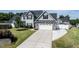 Beautiful two-story home featuring a two-car garage and well-manicured lawn with a long concrete driveway at 77 Redpine Ct, Clayton, NC 27520