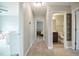 Bright hallway with carpeted floors leading to bedrooms and a bathroom with neutral paint color at 77 Redpine Ct, Clayton, NC 27520