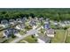 A beautiful home with a manicured lawn and white picket fence sits in a neighborhood surrounded by lush trees at 77 Redpine Ct, Clayton, NC 27520