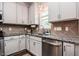 Close up of the kitchen showing the stainless dishwasher, granite countertop and window at 77 Redpine Ct, Clayton, NC 27520