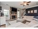 Cozy living room featuring a stone fireplace, dark accent wall, and comfortable sectional sofa at 77 Redpine Ct, Clayton, NC 27520