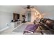 Cozy living room with a dark leather sofa, television, exercise bike, and neutral carpeting at 77 Redpine Ct, Clayton, NC 27520