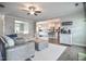 Open concept living space with a comfortable sectional sofa, and a glimpse into the dining room and kitchen at 77 Redpine Ct, Clayton, NC 27520