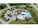 Aerial view of a community pool with two pools, lounge chairs, and a parking lot at 77 Redpine Ct, Clayton, NC 27520
