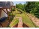Backyard features a brick path and a wooden deck overlooking grass and privacy fence at 817 Stable Fern Dr, Fuquay Varina, NC 27526