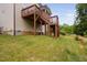 Backyard showing a wooden deck with stairs, green grass and a partial view of trees at 817 Stable Fern Dr, Fuquay Varina, NC 27526