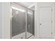 Bathroom featuring a glass-enclosed shower with gray tiled walls at 817 Stable Fern Dr, Fuquay Varina, NC 27526