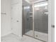 Bathroom featuring a glass-enclosed shower with gray tiled walls at 817 Stable Fern Dr, Fuquay Varina, NC 27526