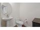 Elegant half-bathroom features a pedestal sink, modern toilet, and tasteful decor at 817 Stable Fern Dr, Fuquay Varina, NC 27526