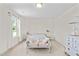 Bright bedroom with plush carpeting, light walls, large windows, and sitting bench at the end of the bed at 817 Stable Fern Dr, Fuquay Varina, NC 27526