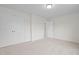 Bedroom with white doors, white walls, and neutral carpet at 817 Stable Fern Dr, Fuquay Varina, NC 27526